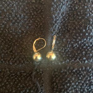Gold dangled earrings with ball